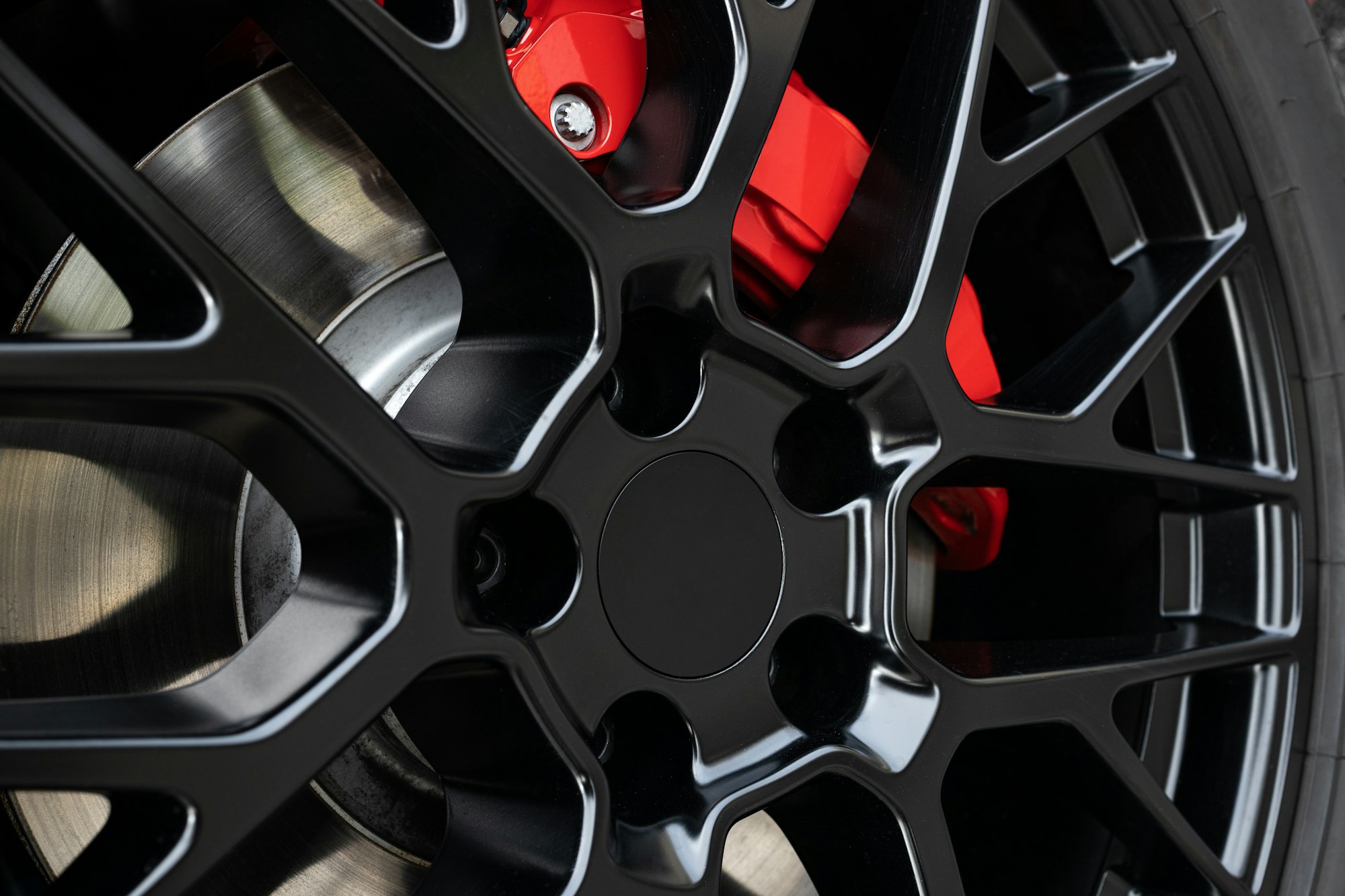 Sport rim and red brake caliper of car